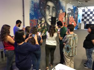 Pessoas fotografando painel pintando em parede